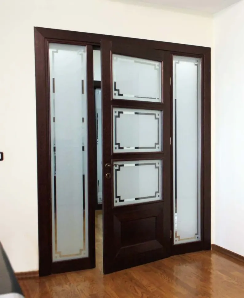 Dark wenge solid wood door with three etched frosted panes between tall frosted glass panels, in a room