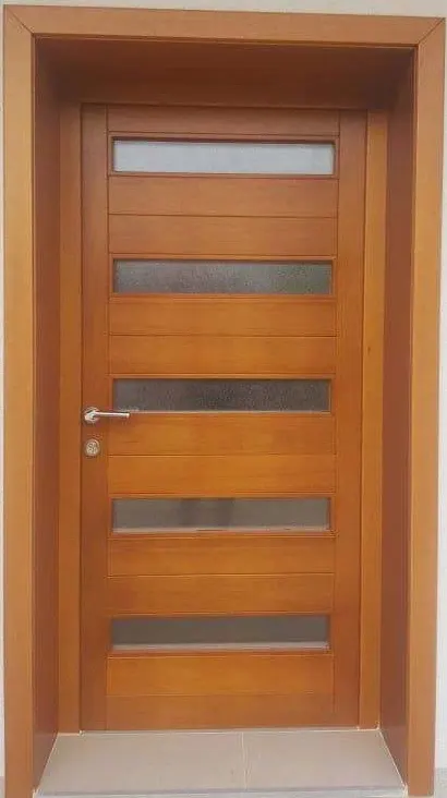 Honey-tone single entrance door of horizontal boards with five frosted glass strips, set in a deep wooden lining